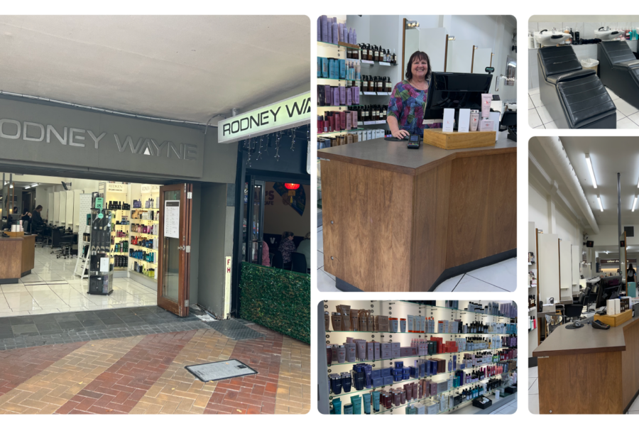 Rodney Wayne salon entrance with signage, receptionist desk, hair product display, and salon interior.