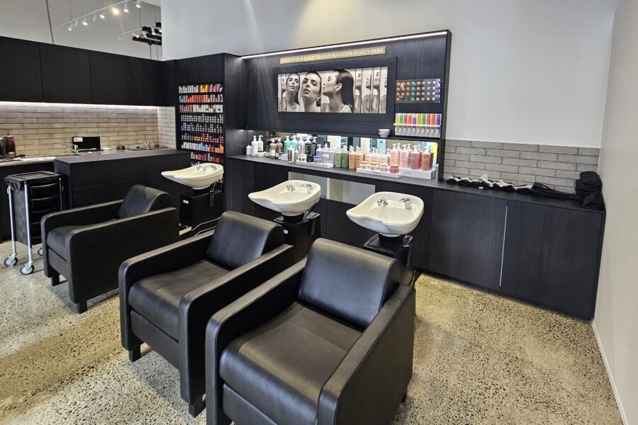 Modern salon shampoo basins with sleek black chairs at Rodney Wayne Commercial Bay.